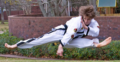 Sky Wood performs the scissor kick, which is a twist kick with the left foot and a side kick with the right foot executed simultaneously. 